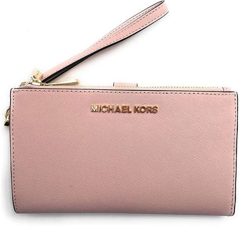 Michael kors wristlet purse - This wallet doesn't have but 3 credit card slots but it holds way more than you would expect! It's got a couple of slip pockets for extra cards and a zip middle pocket for change. It has a nice wristlet strap. Love this wallet, it can fit a iphone 6s without a case on it. Originally posted on macys.com. 